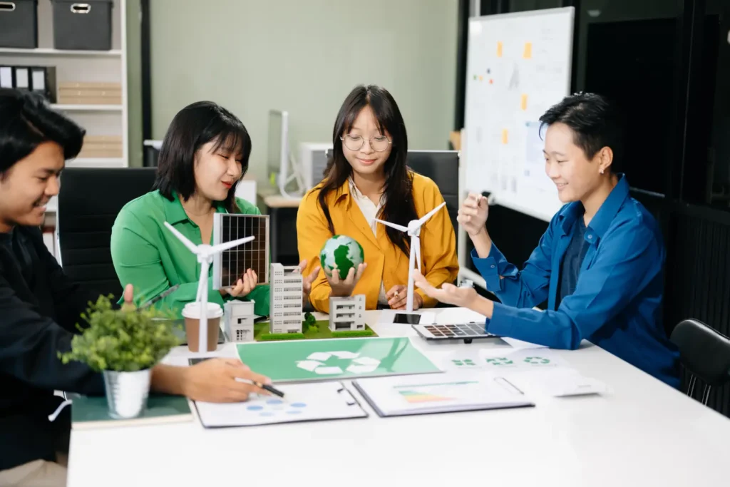 Team collaborating on ESG reporting initiatives using sustainability models and renewable energy concepts.