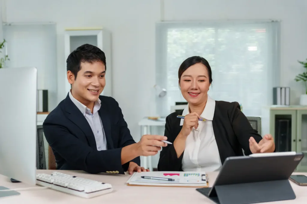 Professional tax consultants advising a business client on tax services and financial documentation in Singapore