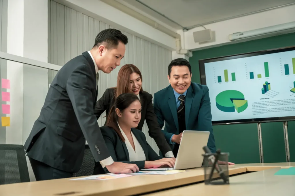 Team reviewing ESG reporting data and sustainability metrics during a business strategy meeting.