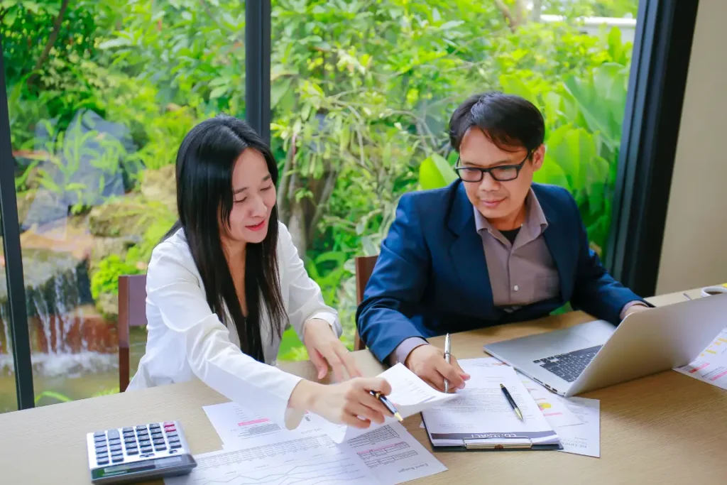 Professional tax consultants analysing reports and advising on tax services for business compliance
